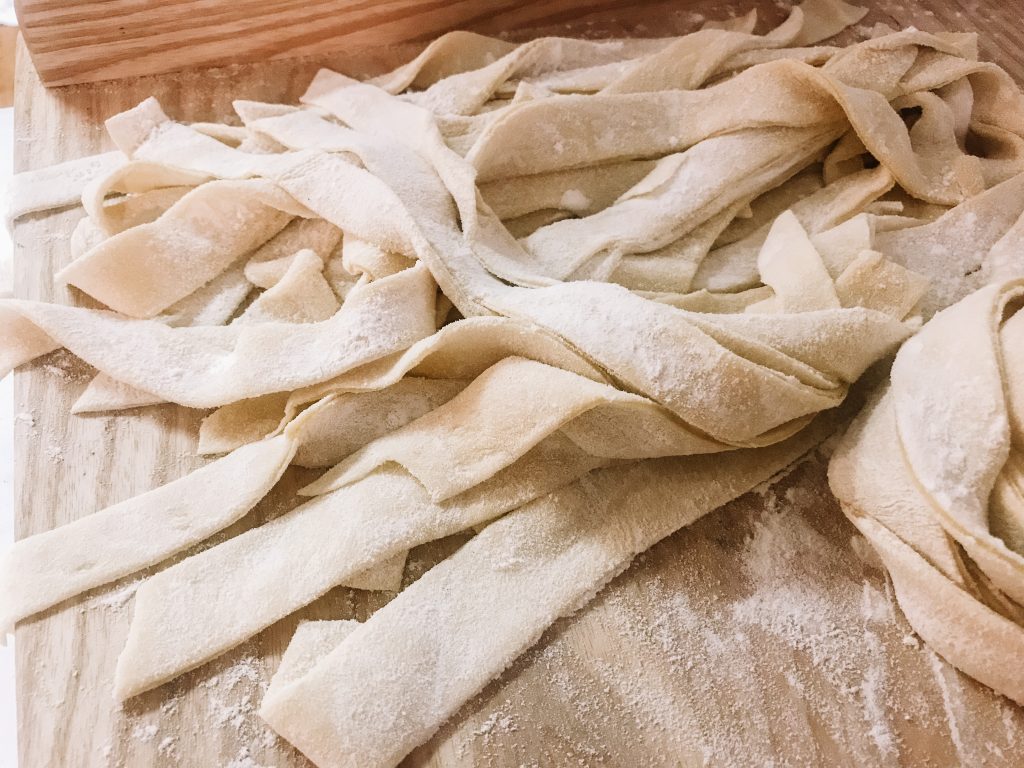 Pile of noodles on a floured board