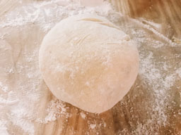 Ball of pasta dough on a floured board